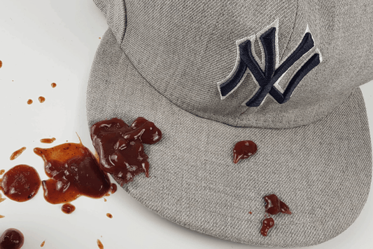 Dirty baseball cap with food stain before cleaning